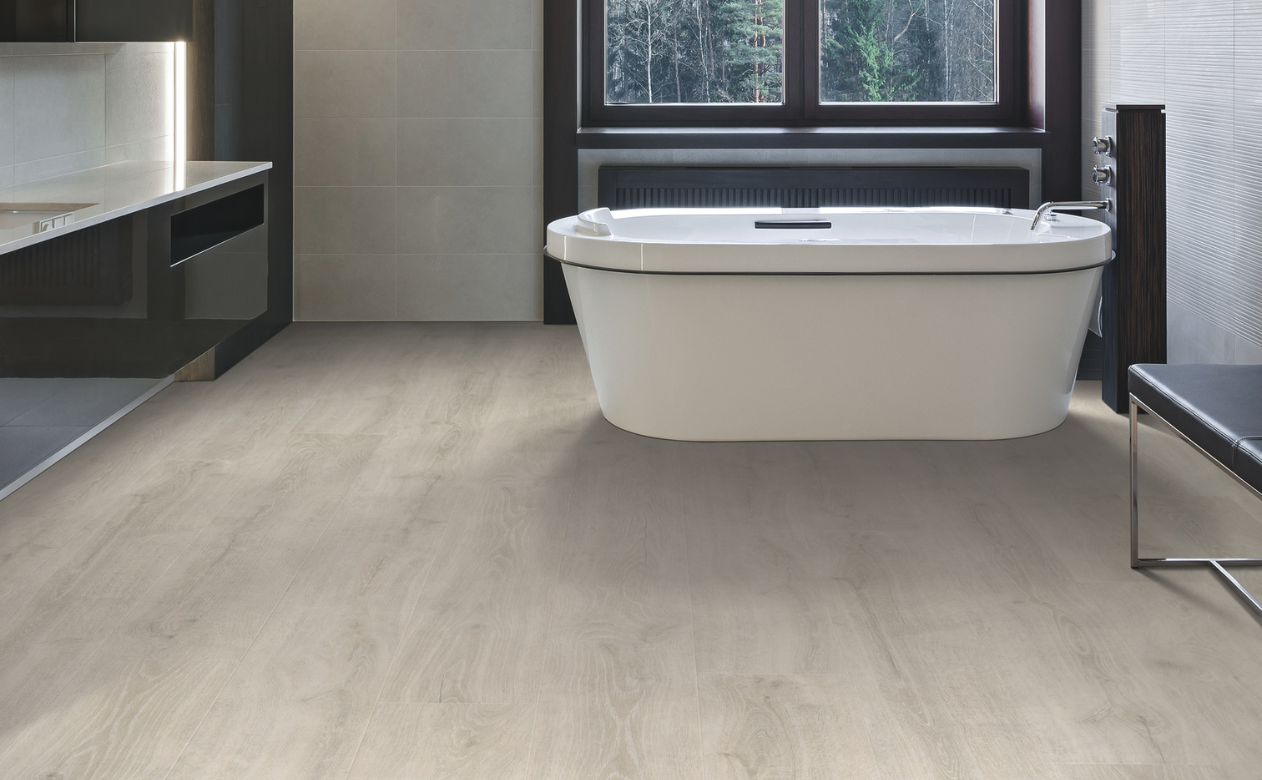 laminate flooring in a bathroom with a tub